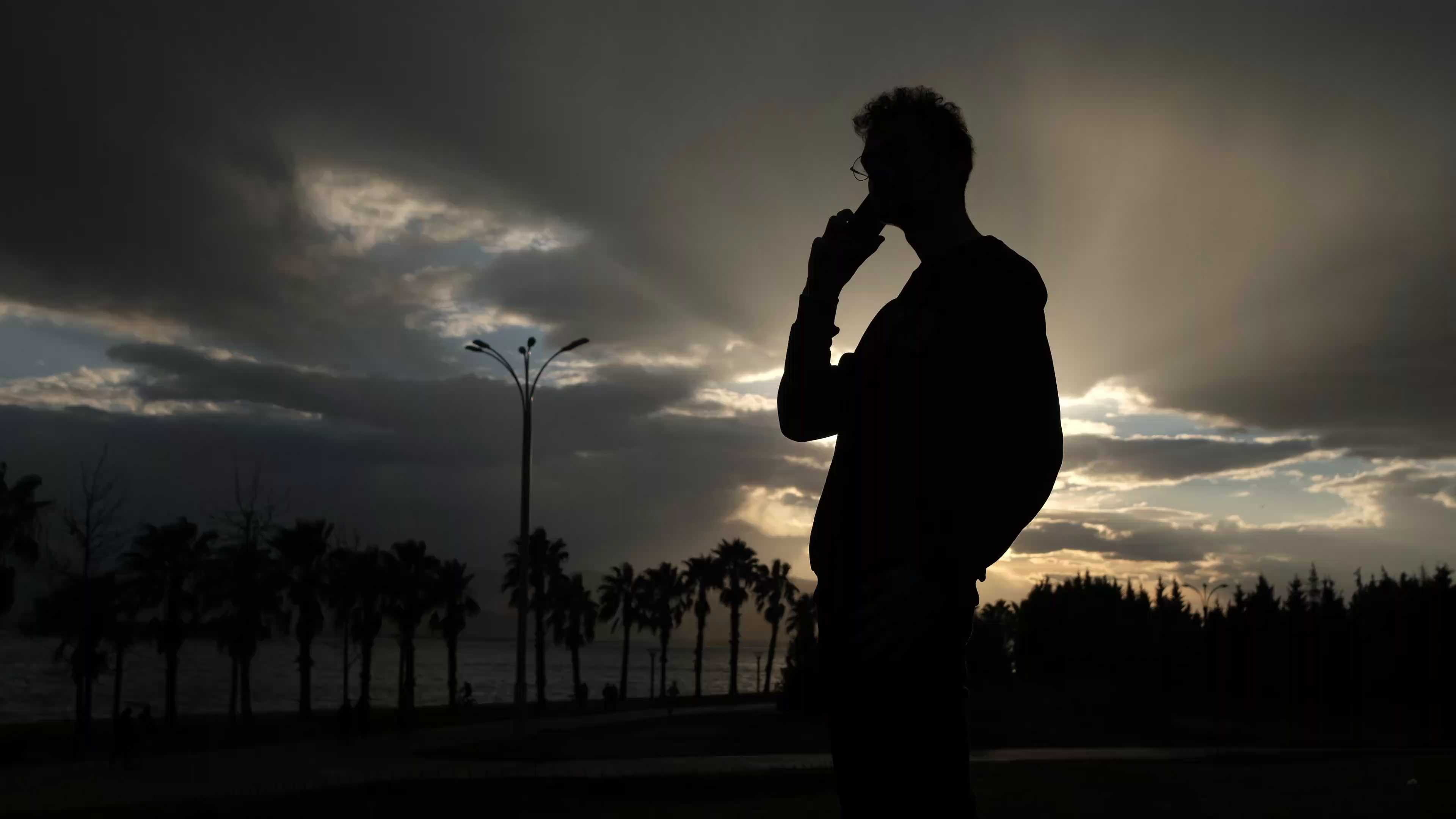 silhouette of person making a phone call