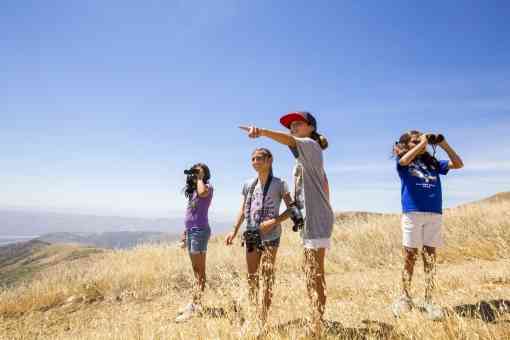 Students from Fillmore Elementary School learn how to use binoculars and search for endangered California condors on Hopper Mountain National Wildlife Refuge. This refuge is directly behind and above the school.
