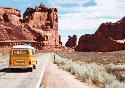 Yellow volkswagen bus on road in Arches NP