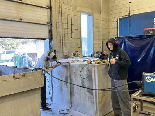 Kodiak High School welding students working on a bear-resistant dumpster courtesy of Isabel Grant, Defender's consultant.