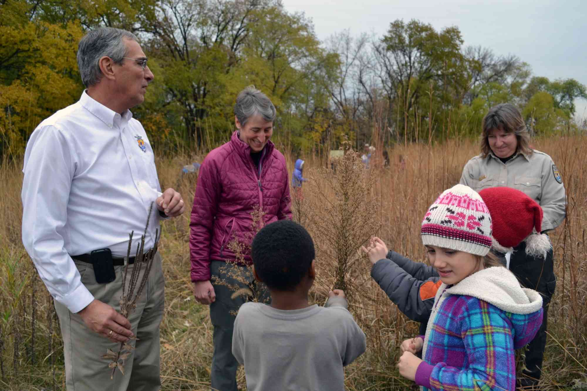 Secretary Sally Jewell and Regional Director Tom Melius help Minneapolis second graders collect native prairie seeds during her visit to Minnesota Valley National Wildlife Refuge 