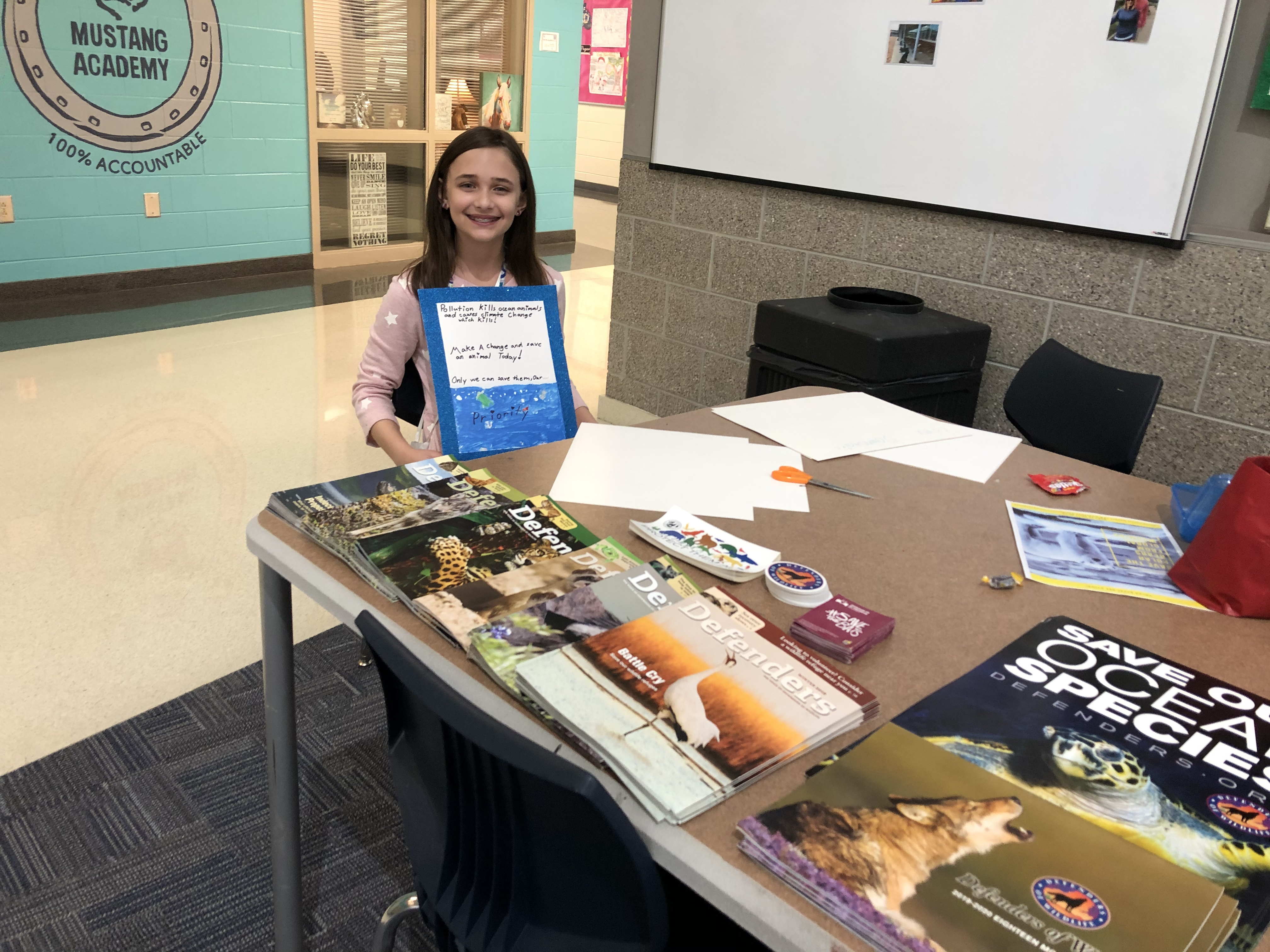 Muller Rd Middle student with Defenders materials