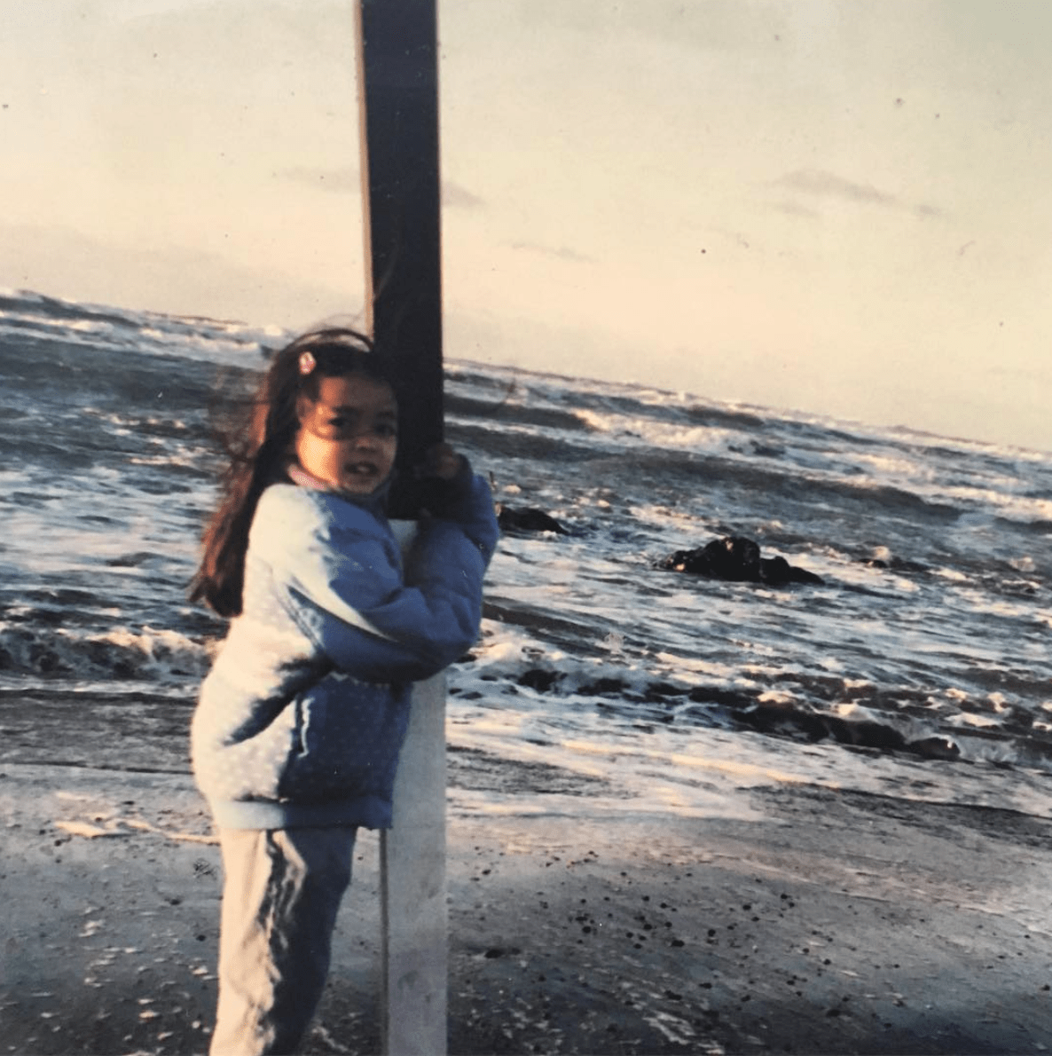 Cristina as a child out by the ocean