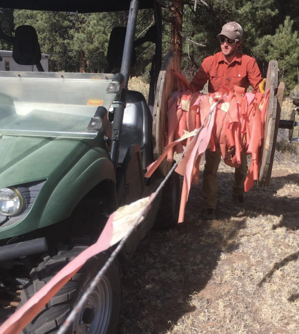 Wildlife Technician rolling flandry using a UTV rig