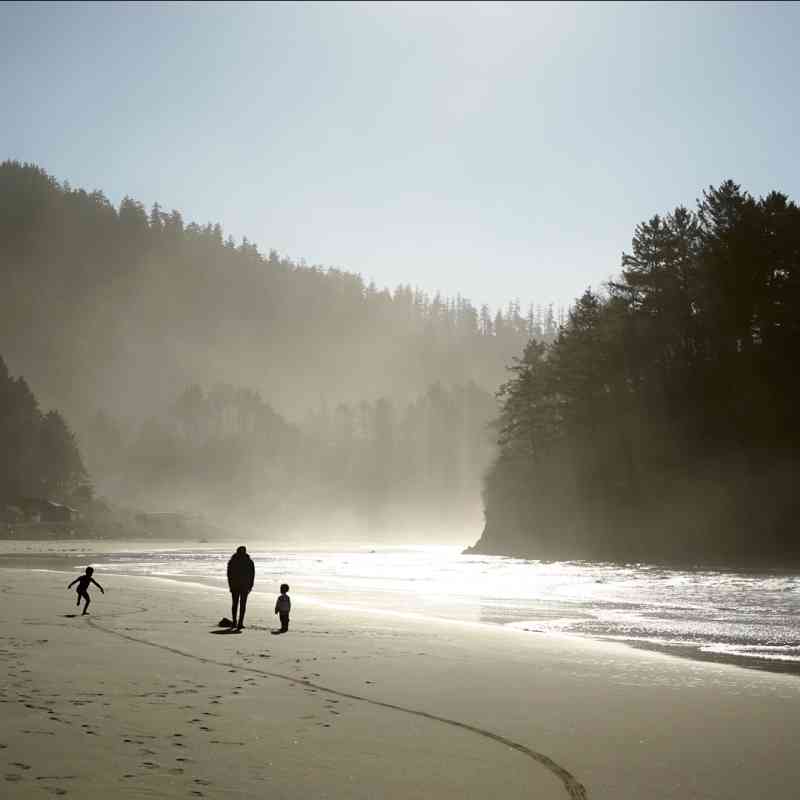 Oregon coast with family walking along beach