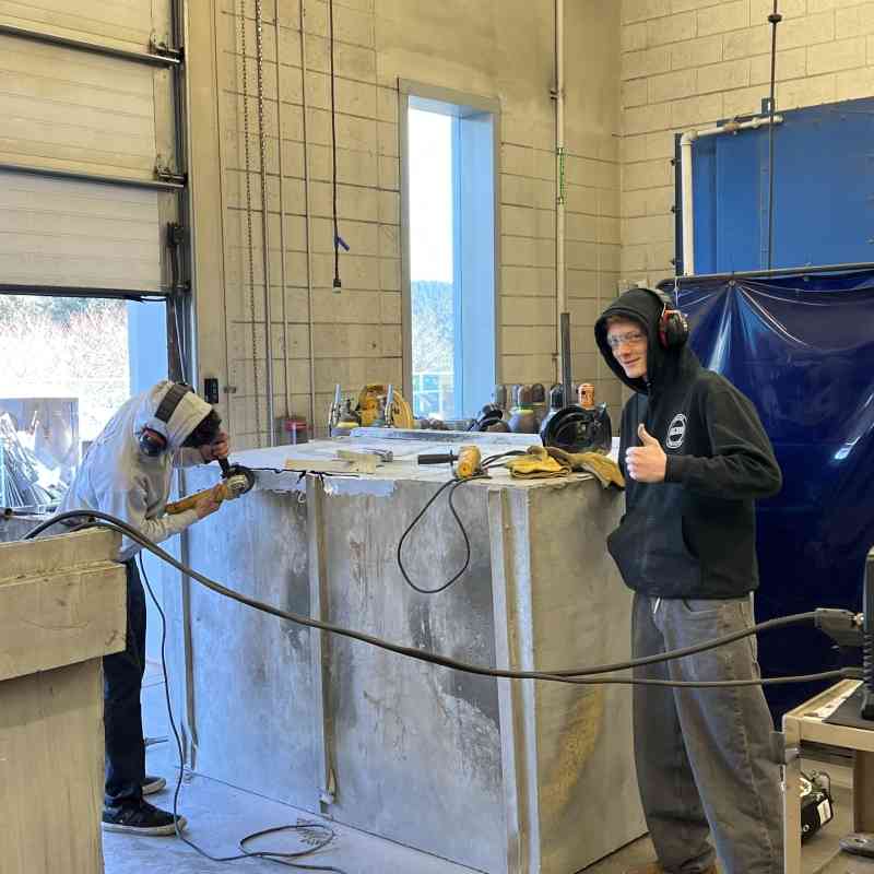Kodiak High School welding students working on a bear-resistant dumpster courtesy of Isabel Grant, Defender's consultant.